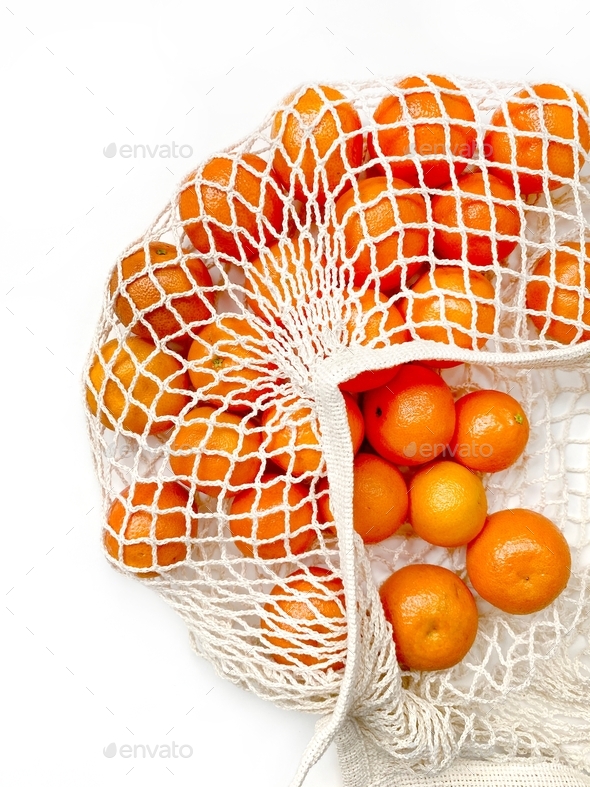 tangerines in a mesh bag Stock Photo by Vladdeep PhotoDune