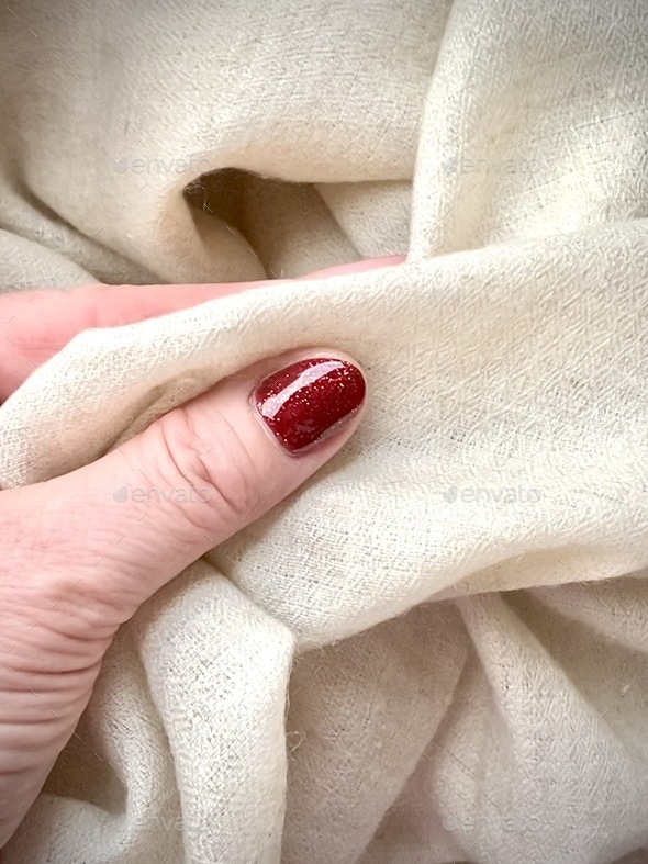 Woman hand touching cashmere shawl