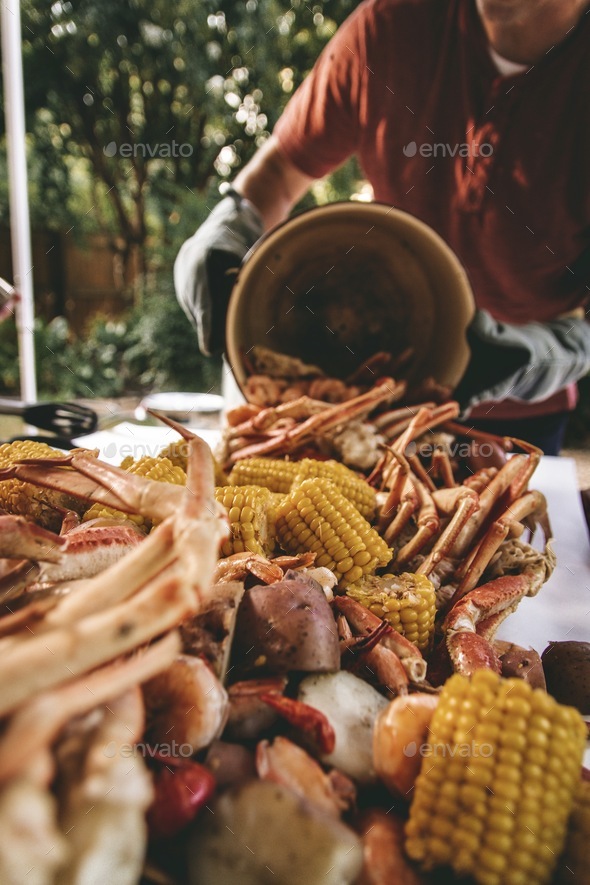 Crabs, crawfish, corn, sausage, & potatoes dumped from the pot. low