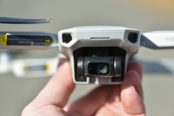 New Drone DJI Mavic Mini 2 ready to fly. Pilot holds drone, close-up view