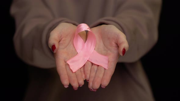 Hands Holding Breast Cancer Ribbon