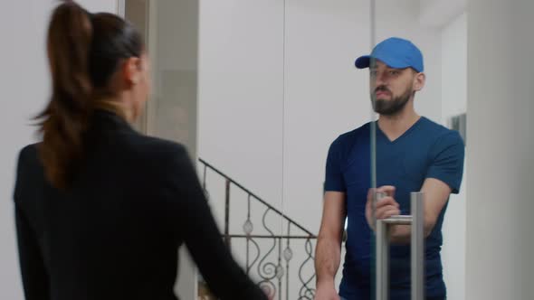 Delivery Man Giving Takeaway Delivery Food Order Package to Businesswoman During Lunchtime alt