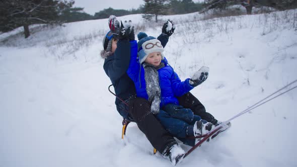 Weekend Outside City in Winter Cute Brothers Have Fun Sledding with Their Parents on a Snowy Road in