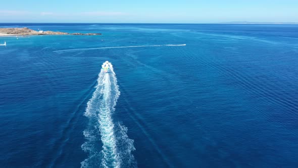 Aerial View of a Motor Boat Towing a Tube. Zakynthos, Greece