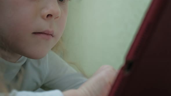Girl Preschooler Uses a Computer Tablet