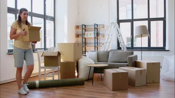 Woman Packing Boxes at and Moving Out House alt