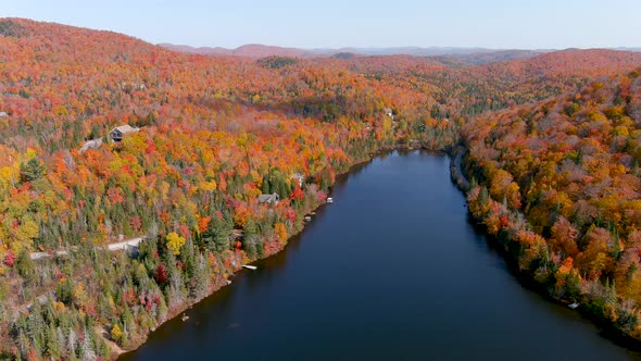 Aerial view of a lake and fall season foliage colors.