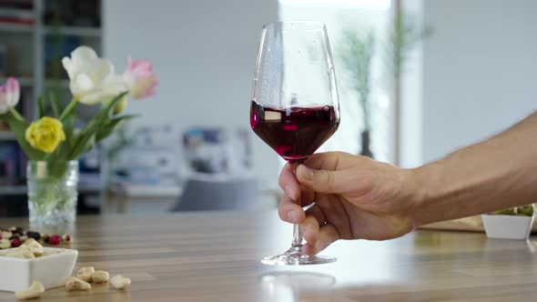 Placing Glass Of Red Wine On Table