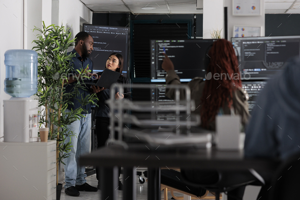 Engineers checking artificial intelligence code - Stock Photo - Images
