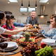 Diverse family having dinner, celebrate weekend reunion gathered together at dining table at home. - PhotoDune Item for Sale