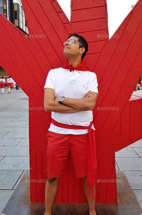 Man posing for a red and white outfit during the San Fermin festival in ...