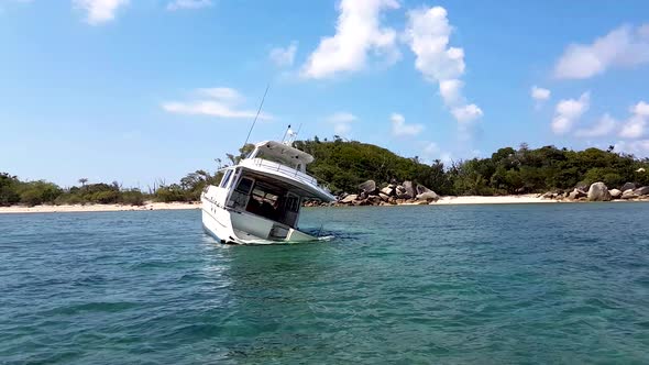 Ship wreck crashed in shallow tropical waters with island in background. alt