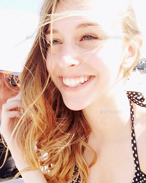 Fun in the sun candid young woman at the beach sun streaks Stock Photo