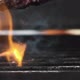 flips over the juicy Burger meat. Slow motion. Close up. - VideoHive Item for Sale