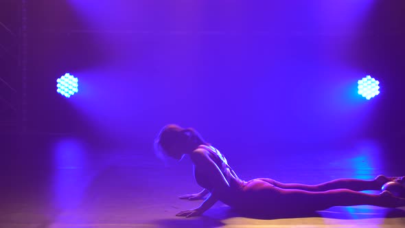 Cute Gymnast Performs Elements of Rhythmic Gymnastics with Ball. Girl Dressed in Burgundy Body alt