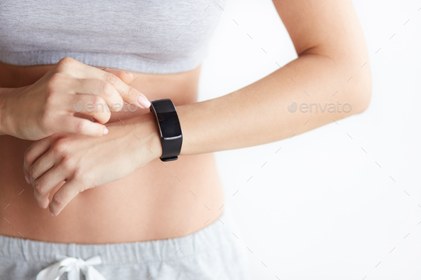 Woman checking her health tracking wearable device