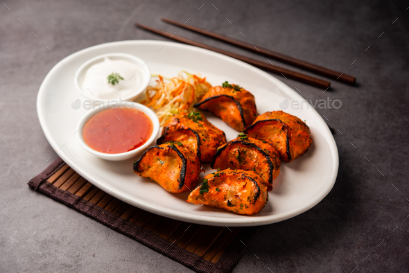 Tandoori momo, veg or non veg in red and cream sauce, served with sauce. Nepal and Tibet recipe