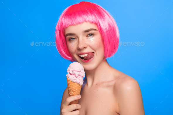 Woman with ice cream licking lips