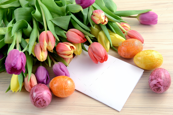 Springtime decoration with tulips, easter eggs and white note paper copy space - Stock Photo - Images