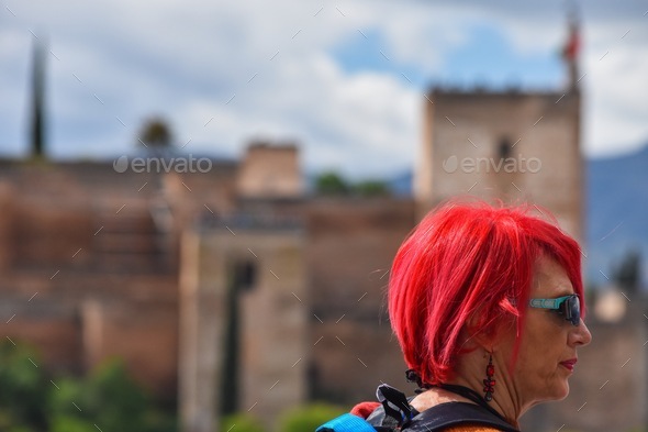 Red hair woman in front of La Alhambra in Granada