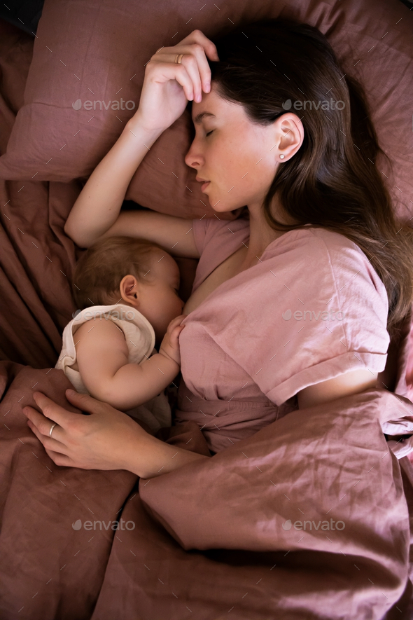 Co-sleeping and breastfeeding mother and daughter.
