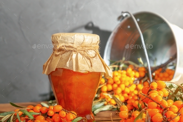 Jam from fresh ripe orange sea buckthorn berries, home canning, vitamin juice in a glass jar