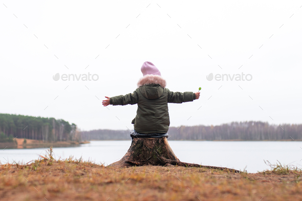 Baby girl forest river lake beautiful view . Autumn, fall. Freedom