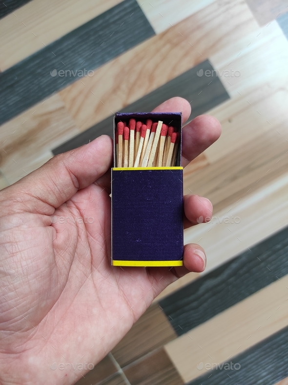 Matchbox and matches on hand, open match box in hand