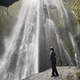 Man looking up at a waterfall - PhotoDune Item for Sale
