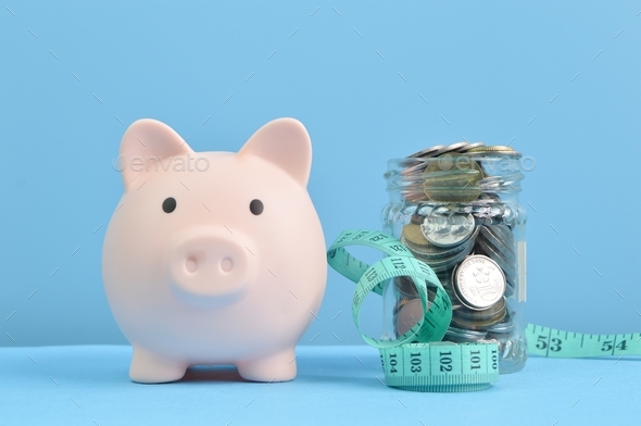 Piggy bank, tape measure and coins. Health concept