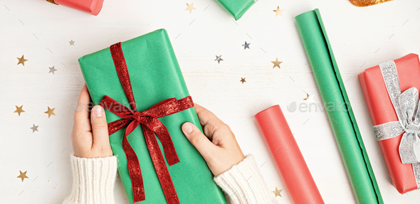 Christmas background with gift boxes and rolls of kraft wrapping