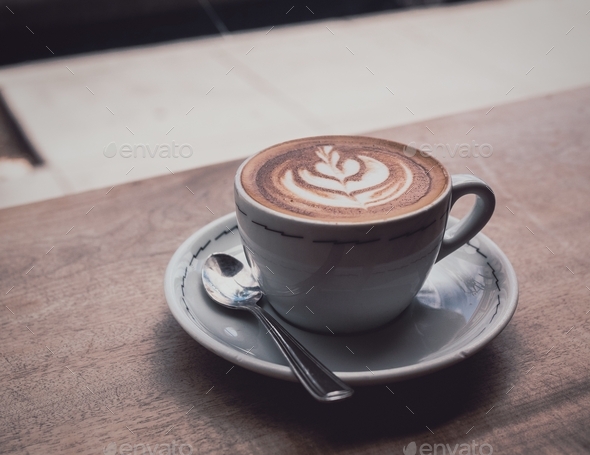 A cappuccino on a windowsill in a coffee shop.  - Stock Photo - Images