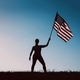 Silhouette of woman holding American flag.  - PhotoDune Item for Sale