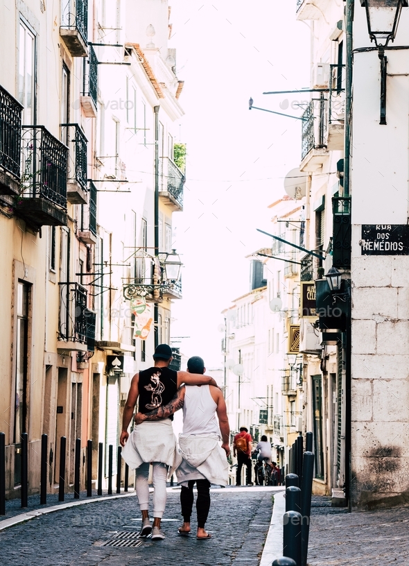 Gay Couple walking on the streets of Lisbon.  - Stock Photo - Images