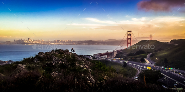 San Francisco Golden Gate Bridge at sunset with hikers - Stock Photo - Images