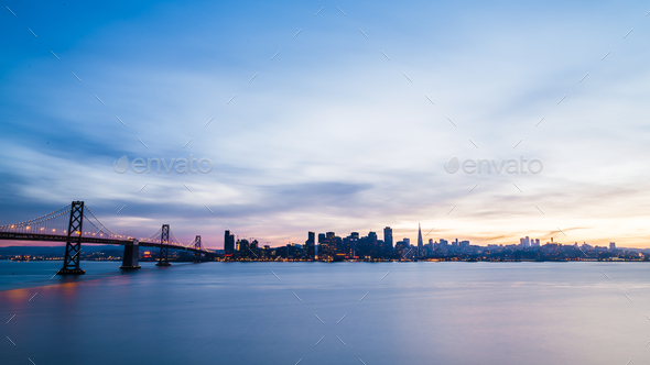 San Francisco skyline at sunset with a silhouette of skyscrapers and the Bay Bridge with dramatic - Stock Photo - Images