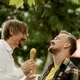 Gay couple on a date eating ice cream in the park - PhotoDune Item for Sale