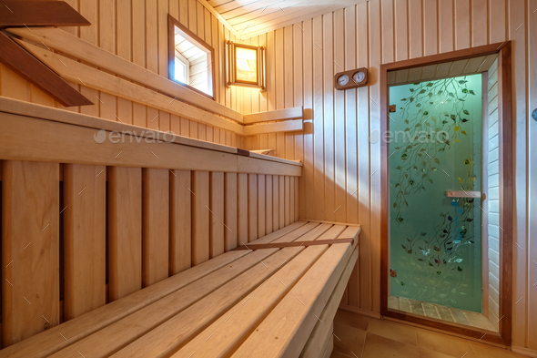 standard design classic wooden russian bath sauna interior with hot stones