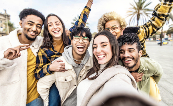 Multiracial group of young people taking selfie portrait picture outdoors  - Stock Photo - Images