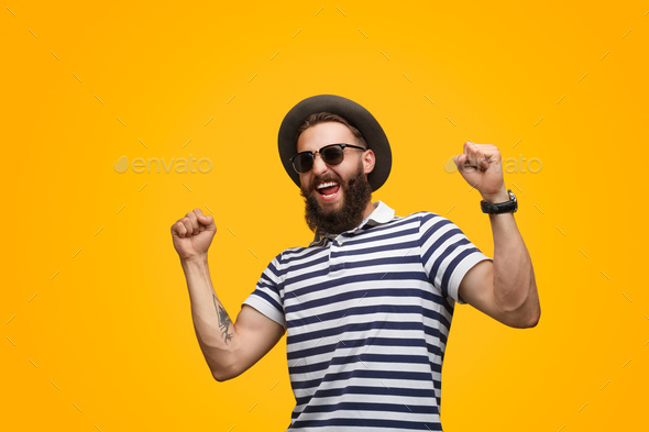 Man in striped T-shirt celebrating success