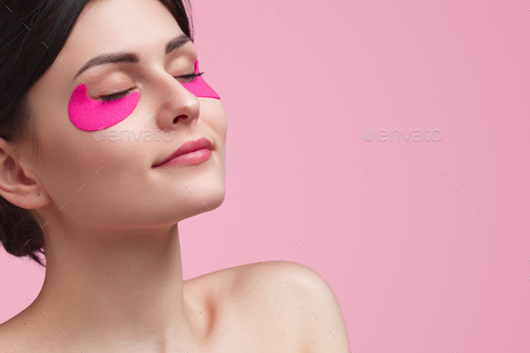 Attractive young woman having under eye mask