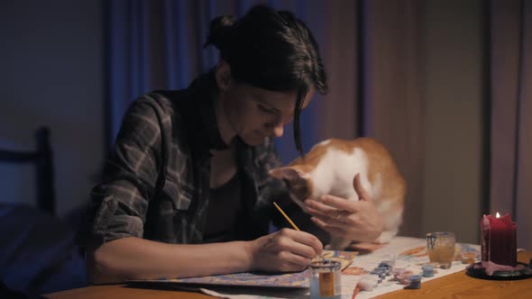 Beautiful Girl Draws a Mandala in a Room with a Ginger Cat