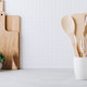 Kitchen utensils. Kitchen wooden tools and kitchenware. White modern kitchen interior background. - PhotoDune Item for Sale