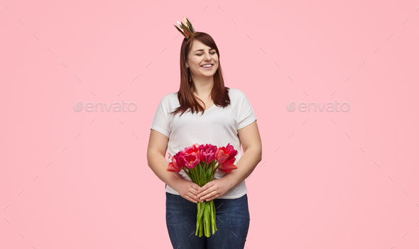 Laughing girl in crown with holiday flowers