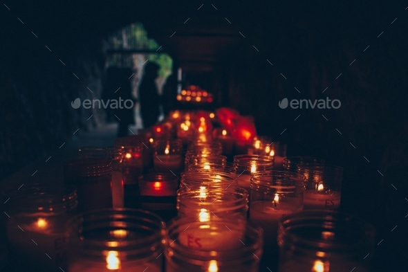 Red candles. Prayer. Religion and faith. Wishes. Vanishing point. Depth of field. Atmospheric mood.