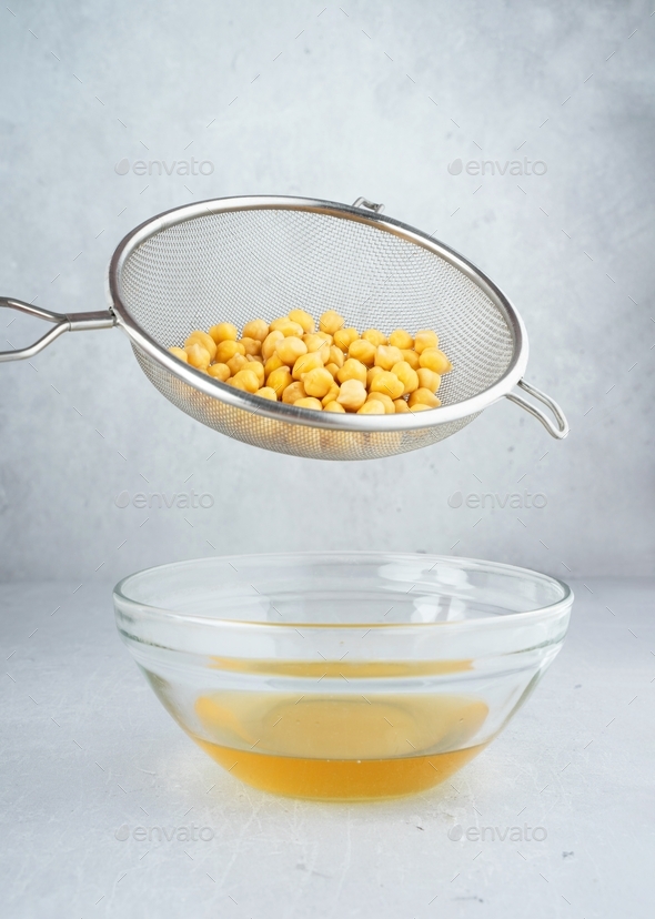 Chickpea water aquafaba. Egg replacement. Vegan concept. Metal sieve