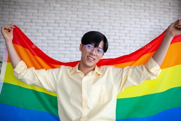 Asian LGBTQ+ gay with flag at home. Concept of LGBTQ. Stock Photo by ...