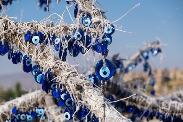 many traditional turkish Evil Eye Bead Amulets on the tree nazar boncuk from blue glass - Stock Photo - Images