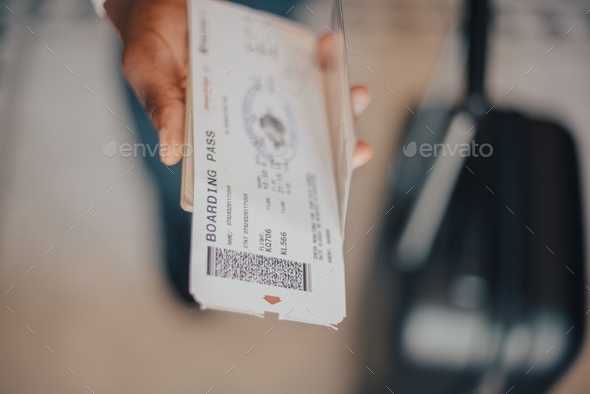 A man holding a passport and boarding pass  - Stock Photo - Images