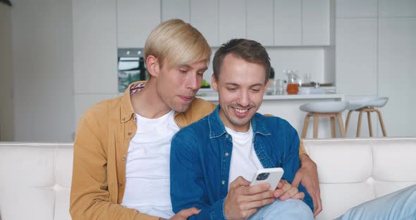 Surprised Two Males Gay Couple Winners Hold Smartphone Read Good News Amazed By Mobile Online Bet alt